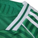 Close-up of Newcastle United Away 2025/26 Player Version jersey showing green fabric and white stripes.