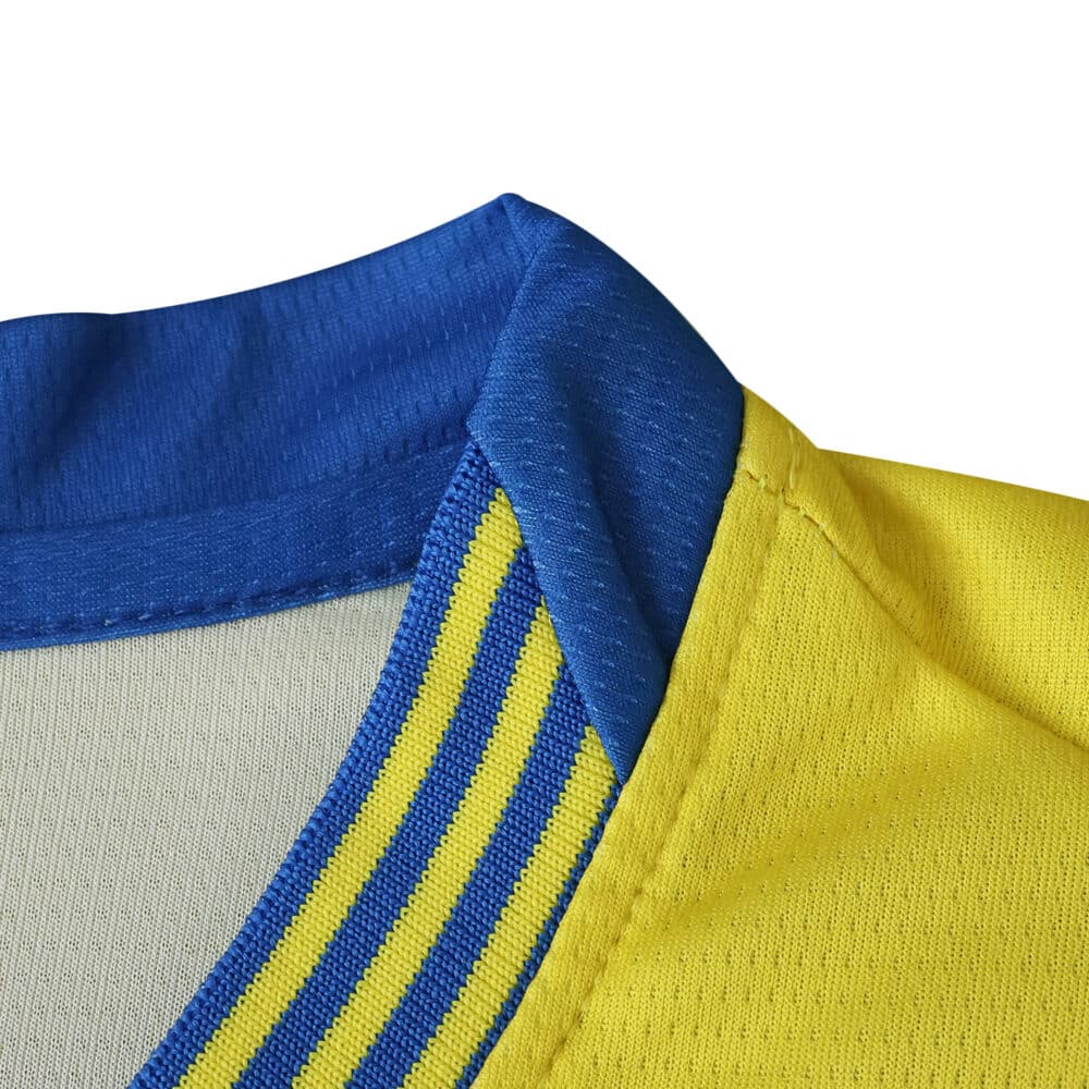 Close-up of Parma Away 2025/26 Fan Version jersey collar in blue with yellow and blue striped trim.
