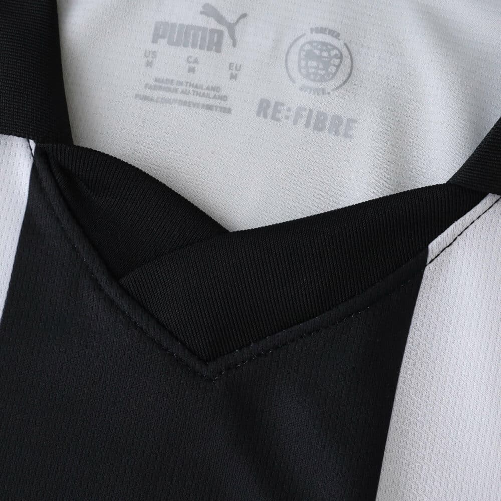 Close-up of the Parma 2025/26 home fan jersey collar, showing Puma logo and black-and-white stripes.