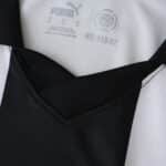 Close-up of the Parma 2025/26 home fan jersey collar, showing Puma logo and black-and-white stripes.