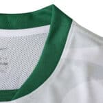 Close-up of Sporting CP Away 2025/26 fan jersey collar with green trim and white mesh fabric.