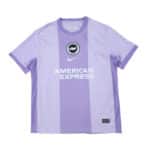 Brighton & Hove Albion 2025/26 away fan jersey in light purple with club crest and sponsor logo.