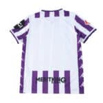 Back view of the Real Valladolid 2025/26 home fan jersey with purple and white stripes and sponsor logos.