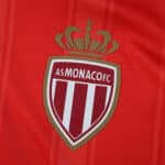 AS Monaco FC crest on the red 2025/26 home player version jersey.