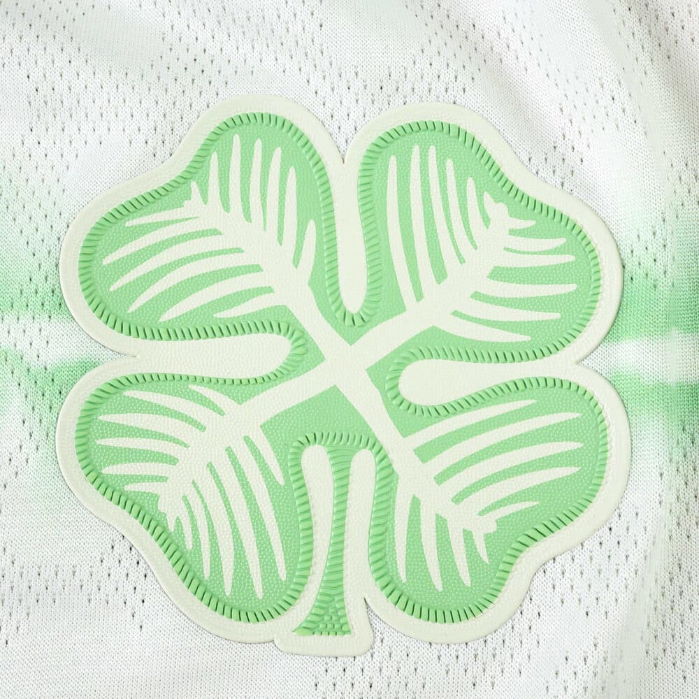 Close-up of the Celtic Third 2025/26 Player Version kit featuring a green four-leaf clover crest.