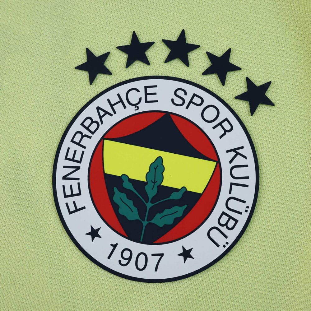 Fenerbahce 2025/26 Away Fan Version badge with club crest and five stars on yellow fabric background.