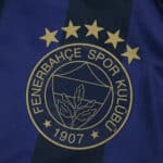 Fenerbahce Third 2025/26 Fan jersey badge with five gold stars and club crest on blue-black fabric.