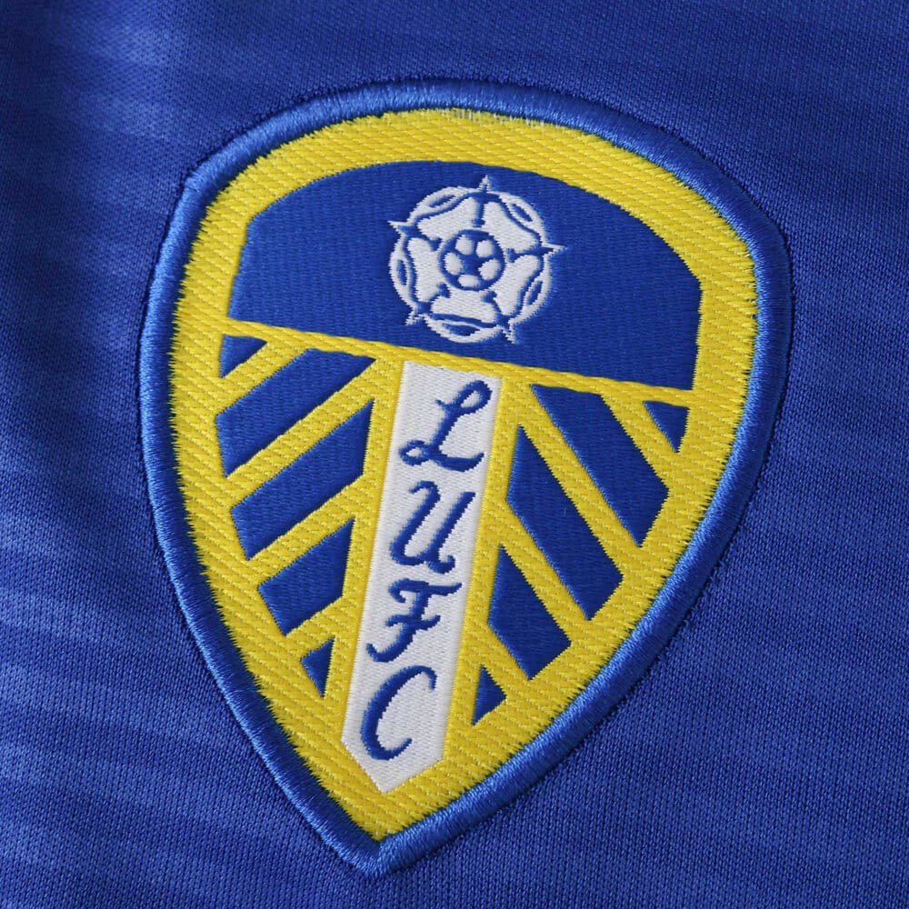 Leeds United 2025/26 Away Fan Version jersey badge with blue, yellow, and white LUFC crest.