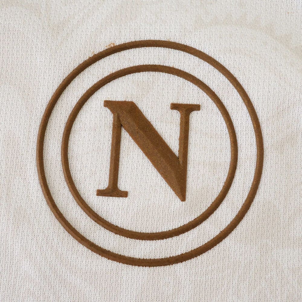 Brown Napoli "N" crest on white fabric for the 2025/26 Away Fan Version jersey.