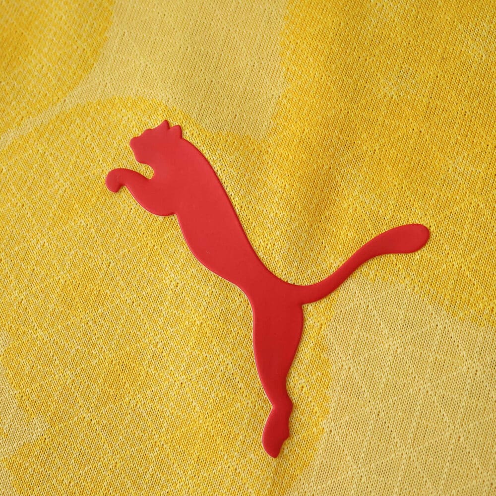 Red Puma logo on yellow fabric of AC Milan 2025/26 Third Player Version jersey.