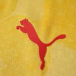 Red Puma logo on yellow fabric of AC Milan 2025/26 Third Player Version jersey.