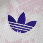 Close-up of the purple Adidas Trefoil logo on the Aston Villa 2025/26 third player jersey fabric.