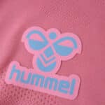 Close-up of the pink Hummel logo on the Celta Vigo Third 2025/26 Fan Version jersey fabric.
