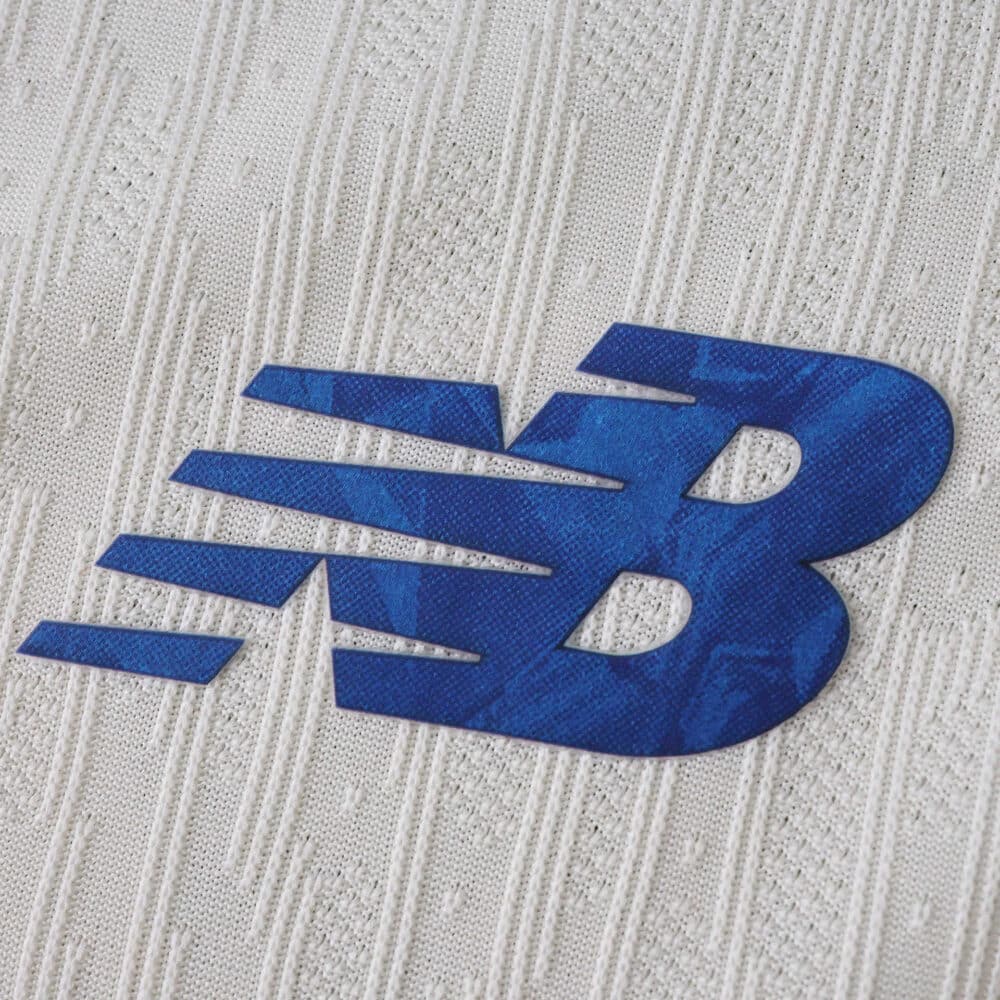Close-up of the blue New Balance logo on the FC Porto Third 2025/26 Player Version jersey fabric.