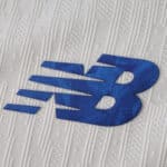Close-up of the blue New Balance logo on the FC Porto Third 2025/26 Player Version jersey fabric.
