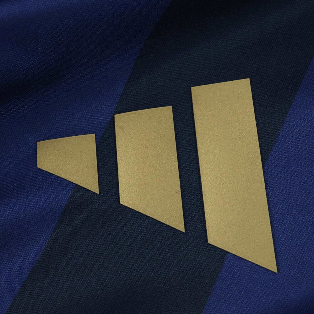 Close-up of the gold Adidas logo on the Fenerbahce Third 2025/26 Fan Version jersey's dark blue fabric.