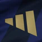 Close-up of the gold Adidas logo on the Fenerbahce Third 2025/26 Fan Version jersey's dark blue fabric.