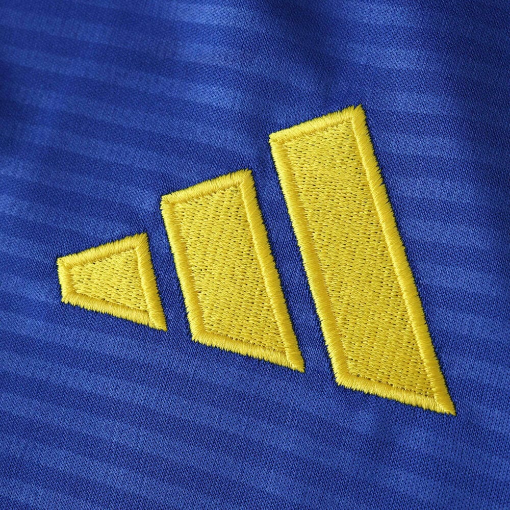 Yellow Adidas logo embroidered on blue Leeds United 2025/26 Away Fan Version jersey fabric.