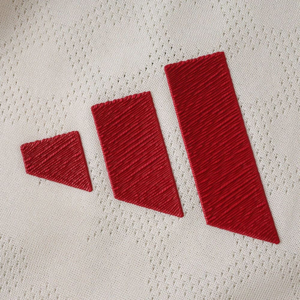 Close-up of the red adidas logo on the Liverpool Away 2025/26 Player Version jersey fabric.