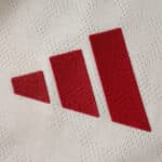 Close-up of the red adidas logo on the Liverpool Away 2025/26 Player Version jersey fabric.