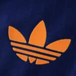Close-up of the orange Adidas Trefoil logo on the Newcastle United Third 2025/26 Player Version shirt.