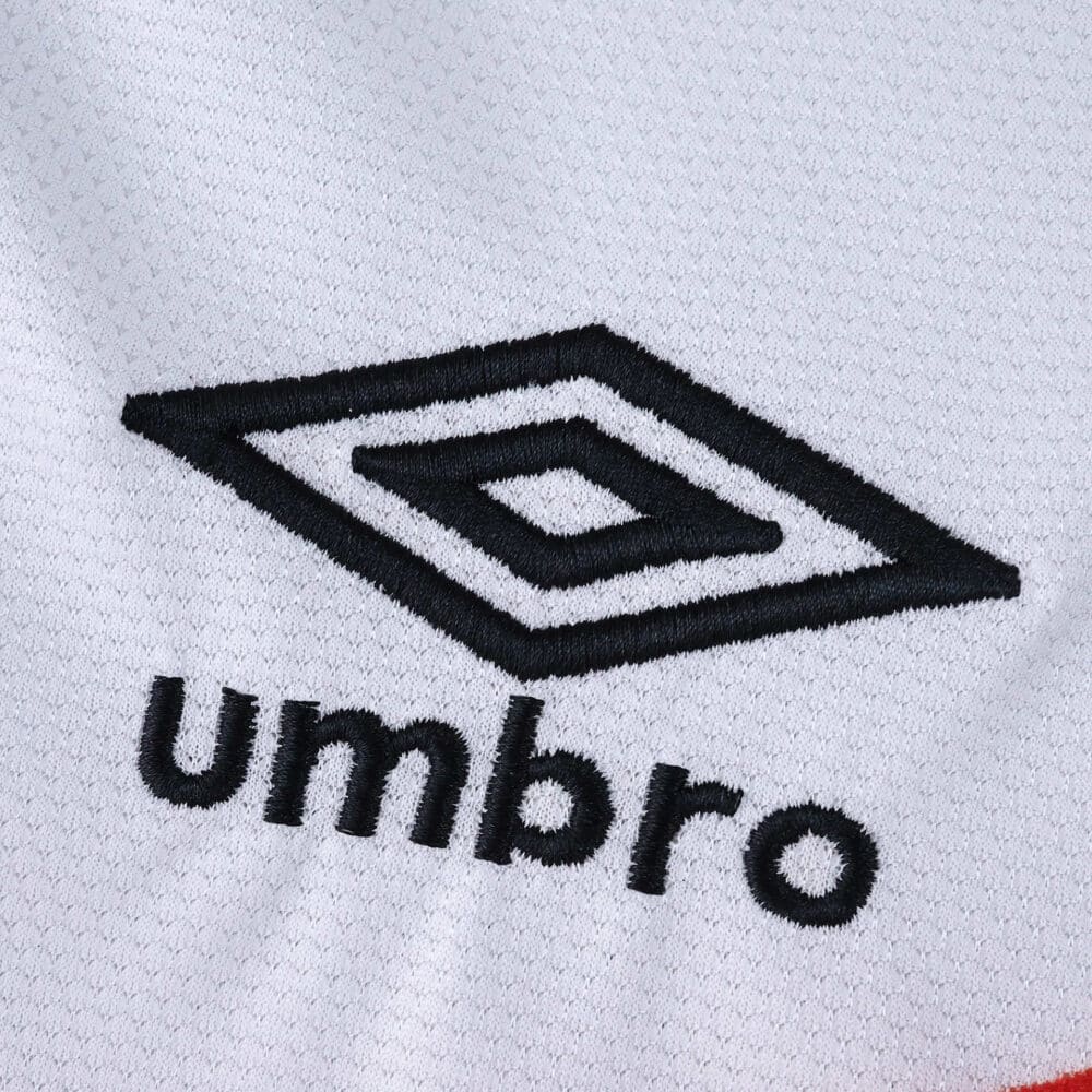Close-up of Umbro logo on the Rayo Vallecano 2025/26 Home Fan Version jersey fabric.