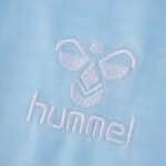 Close-up of white Hummel logo embroidered on the light blue Real Betis 2025/26 away fan jersey fabric.