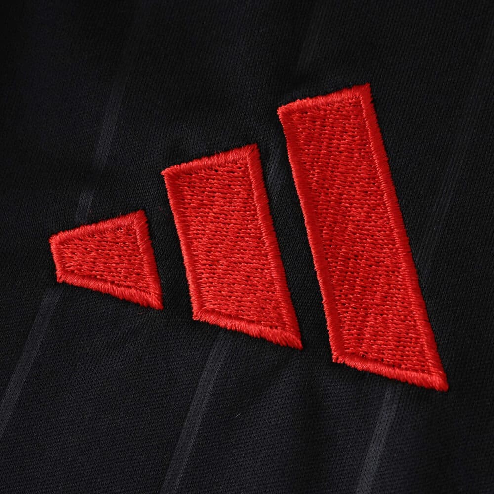 Close-up of the red adidas logo on the black Sevilla FC Third 2025/26 Fan Version jersey.