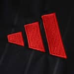 Close-up of the red adidas logo on the black Sevilla FC Third 2025/26 Fan Version jersey.
