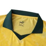 Close-up of AC Milan Third 2025/26 Player Version jersey collar, yellow with green trim and Puma logo.