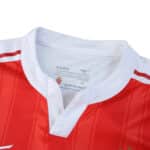 Close-up of AS Monaco 2025/26 Home Player Version jersey collar, showing red and white design with logo.