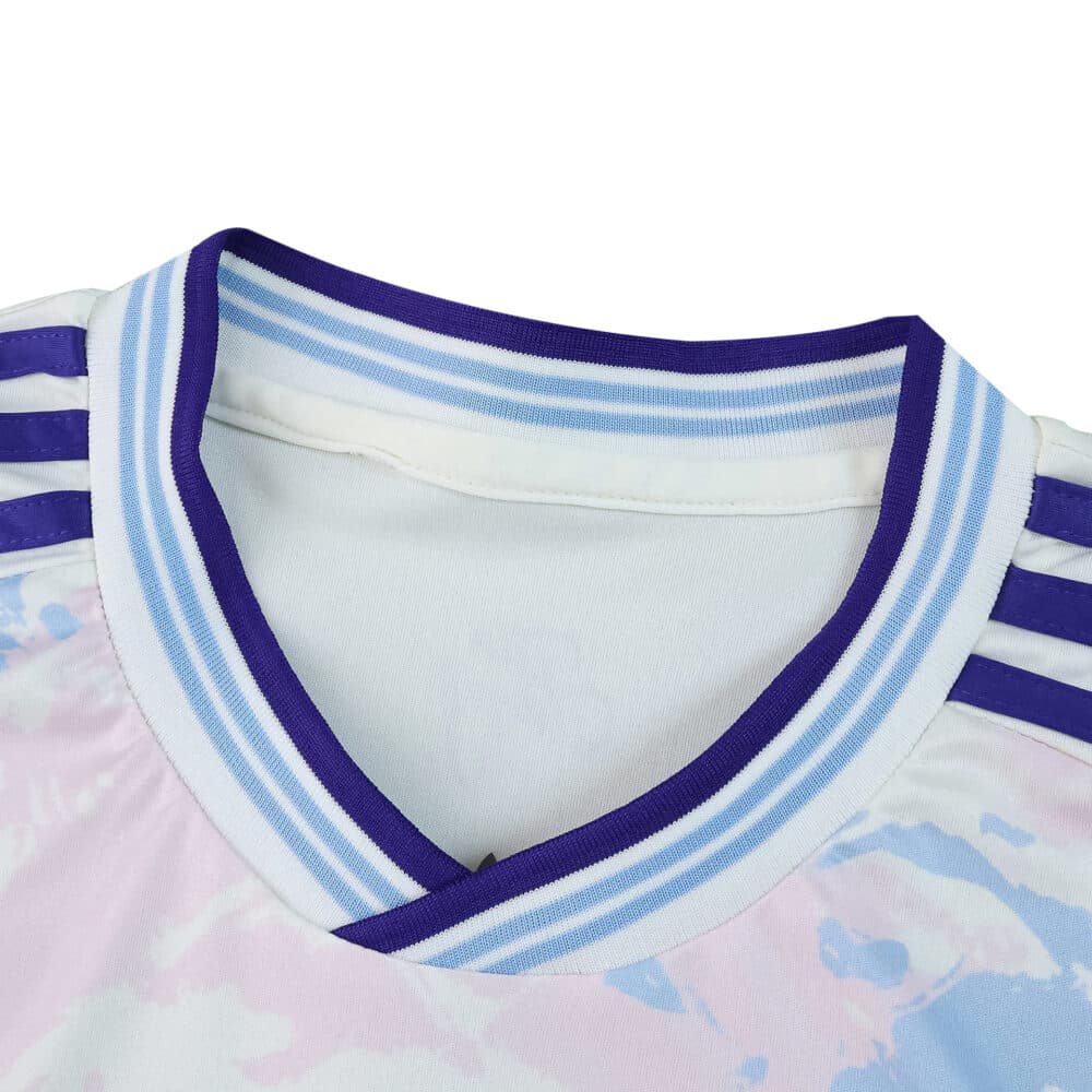 Close-up of Aston Villa 2025/26 third fan jersey collar with blue and purple trim and shoulder stripes.