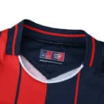 Close-up of the Bologna Home 2025/26 Fan Version jersey collar, showing red and navy stripes.