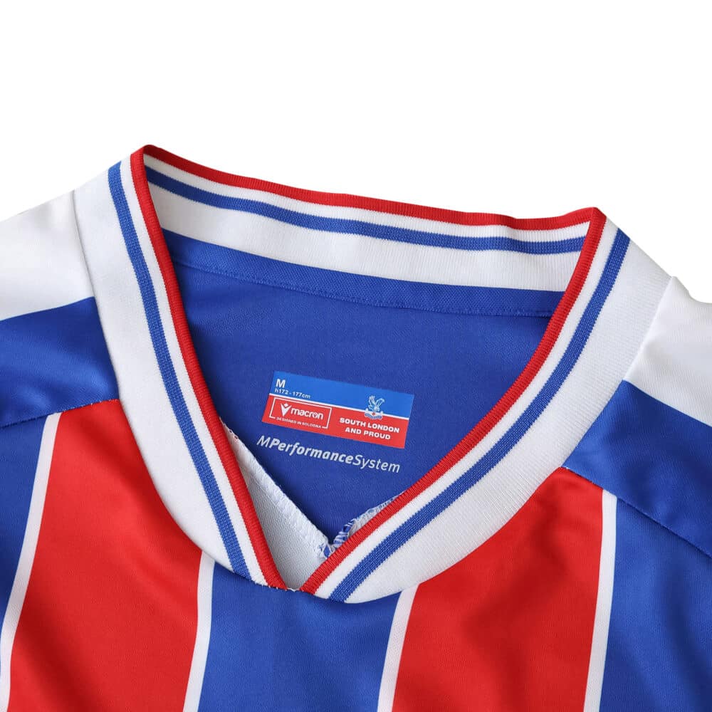 Close-up of Crystal Palace Home 2025/26 Fan Version jersey collar with red, blue, and white stripes.