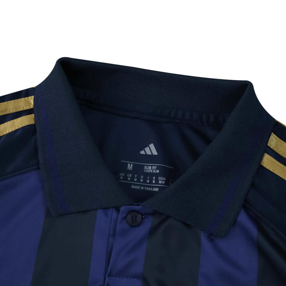 Close-up of Fenerbahce Third 2025/26 Fan Version jersey collar with gold Adidas stripes on shoulders.