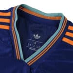 Close-up of Newcastle United Third 2025/26 Player Version collar with teal trim and orange stripes.