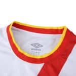 Close-up of Rayo Vallecano 2025/26 Home Fan jersey collar with red and yellow trim and Umbro logo inside.