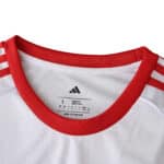 Close-up of the Sevilla FC 2025/26 Home Fan Version jersey collar with red trim and Adidas stripes.