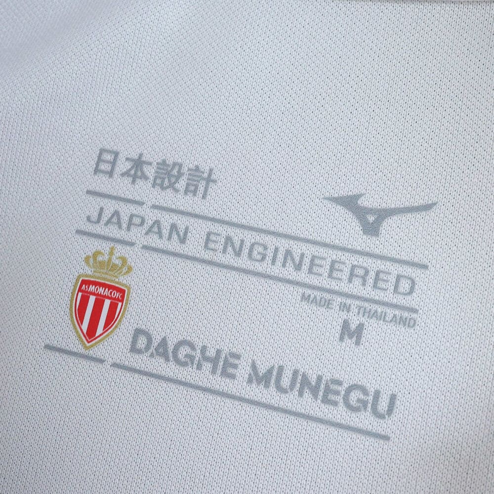 Close-up of AS Monaco Home 2025/26 Fan Version shirt label with club crest and "Japan Engineered" text.