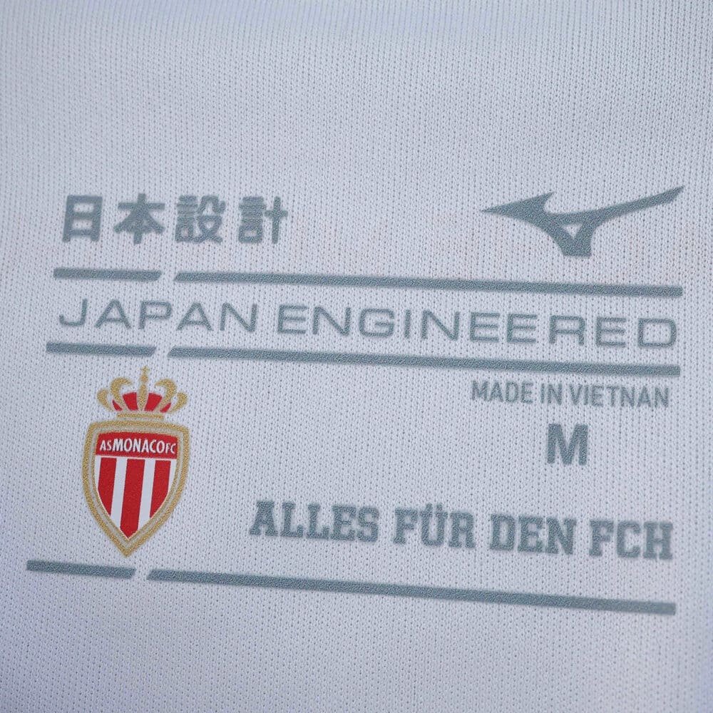 Close-up of AS Monaco 2025/26 Home Player Version shirt tag showing club crest and Japan Engineered label.