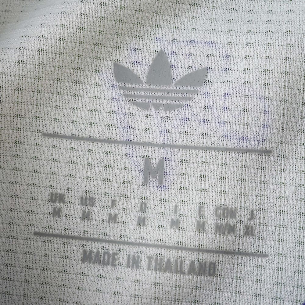 Close-up of the inner collar label on Aston Villa Third 2025/26 Player Version shirt, showing size and branding.