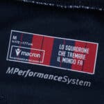 Product tag for Bologna Home 2025/26 Fan Version, Macron branding, size M, slogan in Italian.
