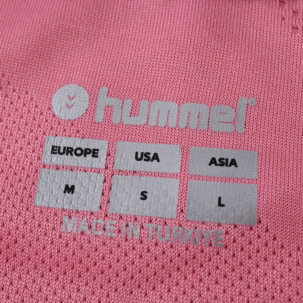 Close-up of Celta Vigo Third 2025/26 Fan Version jersey neck label with size info and Hummel logo.