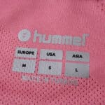 Close-up of Celta Vigo Third 2025/26 Fan Version jersey neck label with size info and Hummel logo.