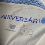 Close-up of FC Porto Third 2025/26 Fan Version jersey collar with “ANIVERSÁRIO” and New Balance logo inside.