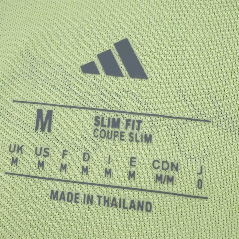 Close-up of Fenerbahce Away 2025/26 Fan Version jersey size tag, showing Adidas logo and sizing details.