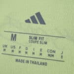 Close-up of Fenerbahce Away 2025/26 Fan Version jersey size tag, showing Adidas logo and sizing details.