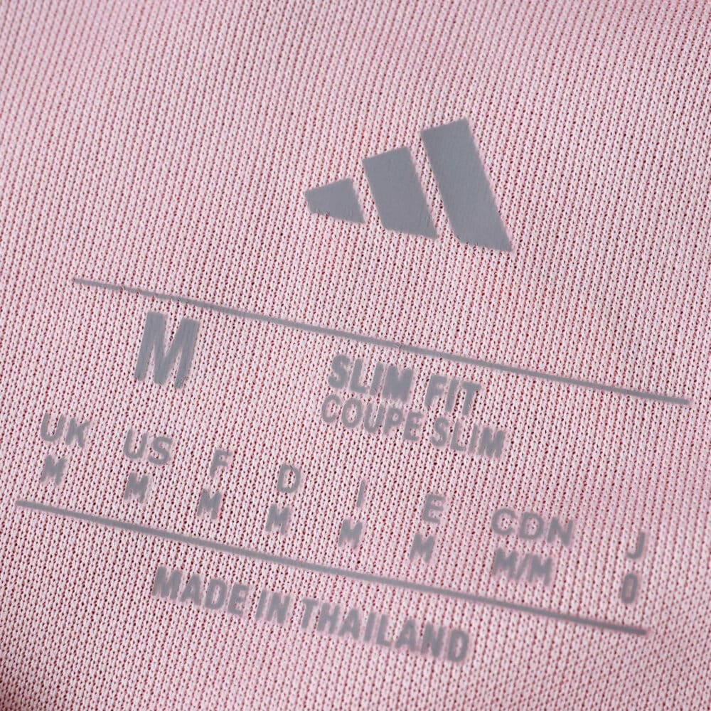 Close-up of the inner label on the Granada Home 2025/26 Fan Version shirt, showing size and fit details.