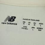 Close-up of Lille LOSC Away 2025/26 Fan Version shirt label showing New Balance logo and size details.
