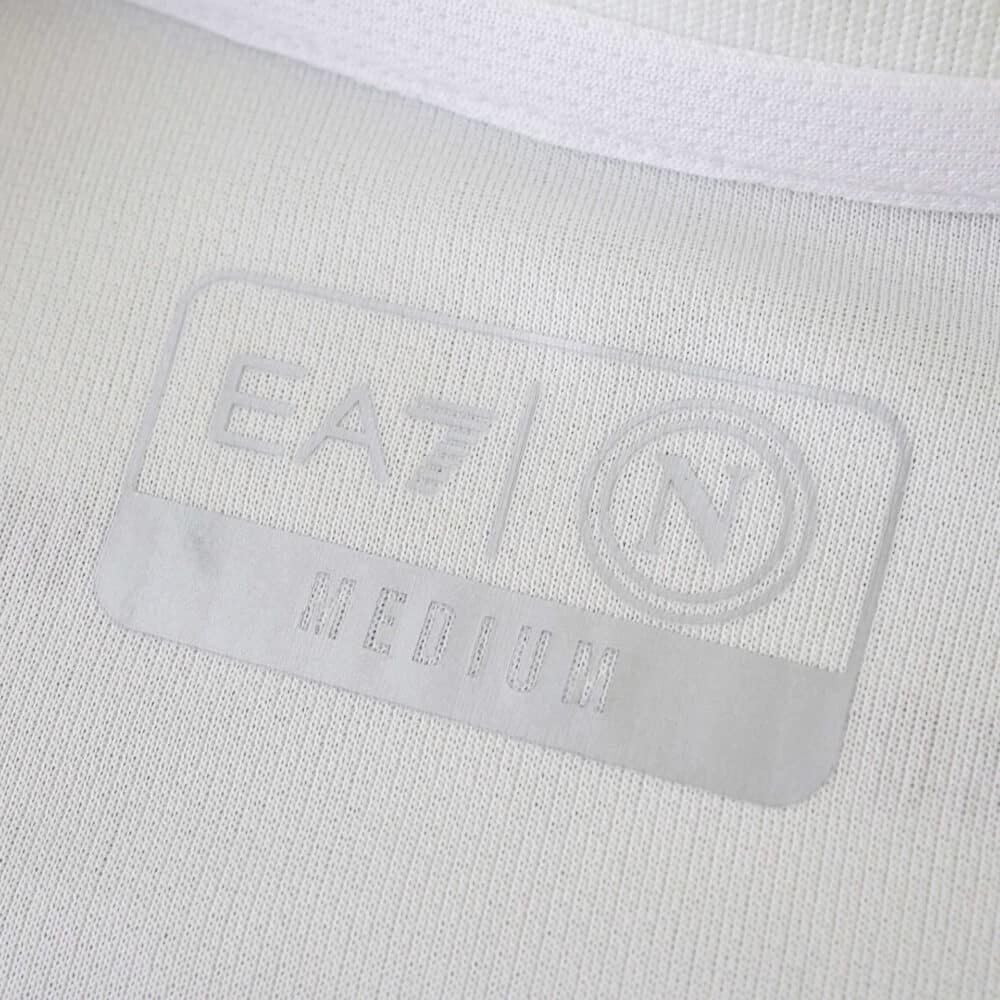Close-up of the Napoli Away 2025/26 Fan Version jersey showing embossed EA7 and SSCN logos.